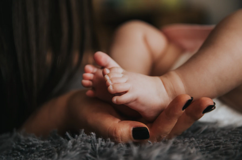 Mother holding her baby in her arms