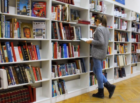 Person looking through a library