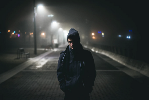 Man walking along the street lonely at night