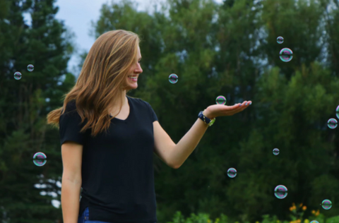 Adult playing with bubbles in the park