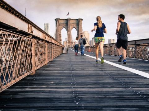 Runners along a bridge