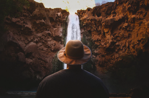 person standing in front of a waterfall