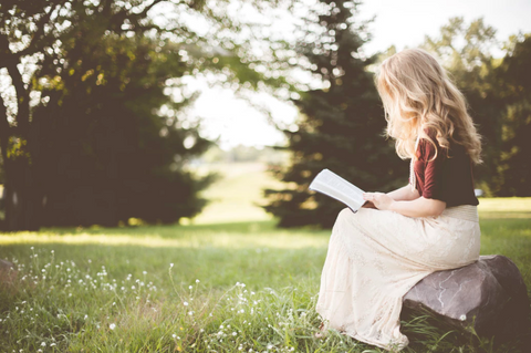 girl reading a book outdoors