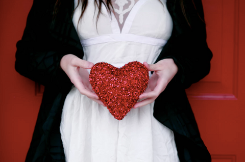 woman holding a sparkle heart