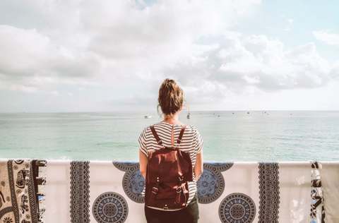 woman standing alone with backpack