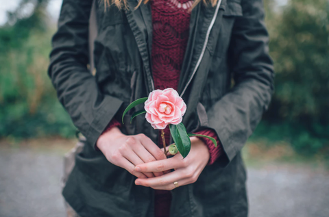 woman holding a flower