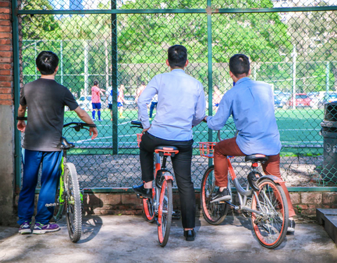 men bike riding together