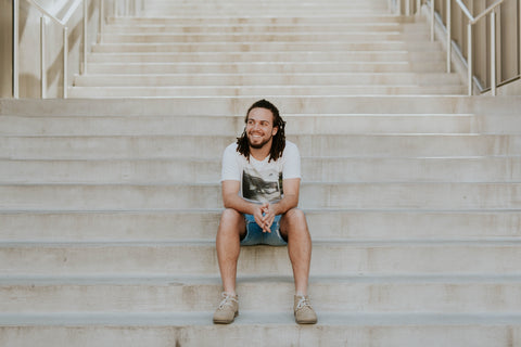 Man smiling sitting on stairs