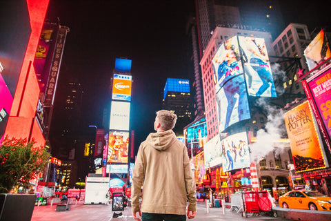 Man standing in a busy city