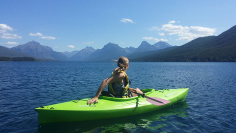 Woman on a kayak on a beautiful lake