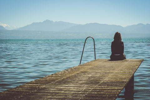 Sitting on the end of a pier at a beach