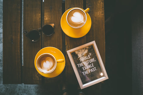 Coffees on a table and a motivating book