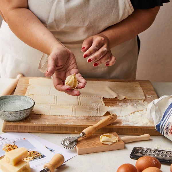 Fresh tortelloni pasta being prepared before drying