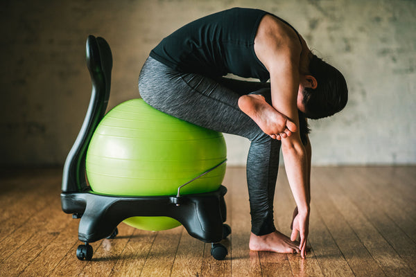 3 Stretches To Beat Back Pain Without Getting Up From Your Chair