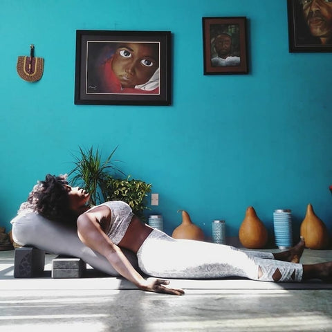 Woman reclined on bolster