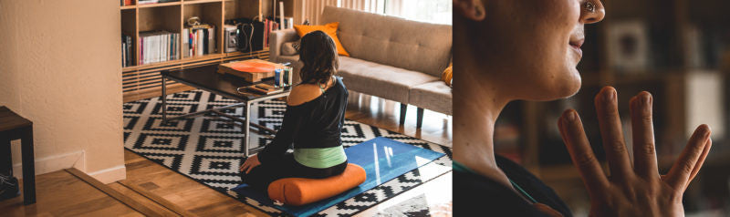 woman sits and meditates in living room