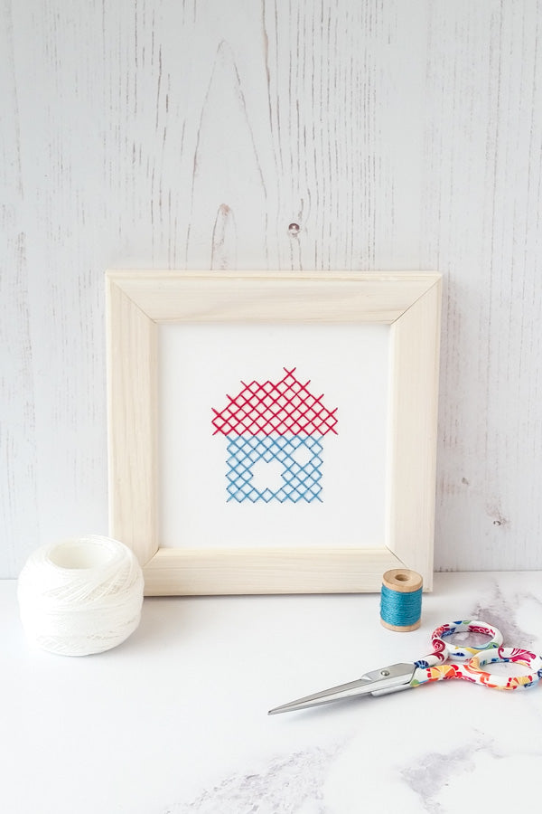 Cross stitch house on paper