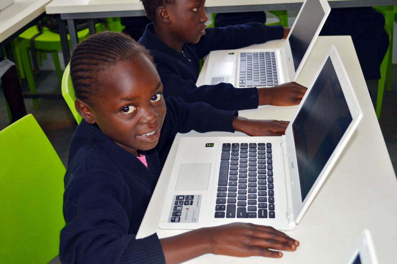 girls in drc with computers at school