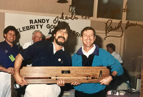 Country music star Randy Ownes receiving his Otey Crisman putter