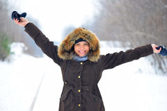 Woman standing with snowy background