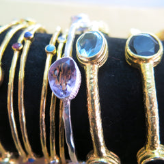 Gold plated bangles glittering with semi-precious stones