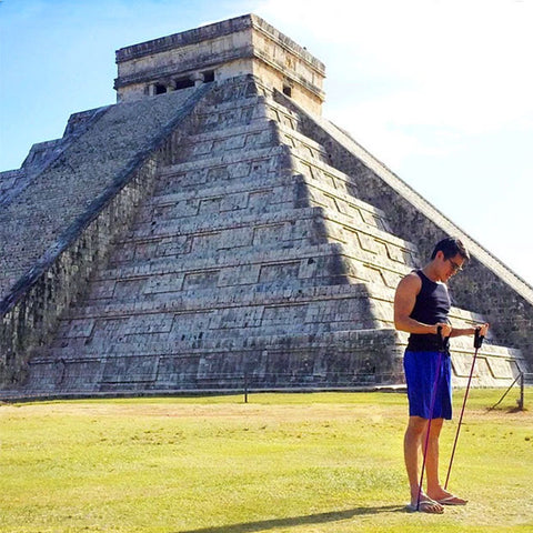 Man uses xertube to workout in front of ancient Mexican ruin