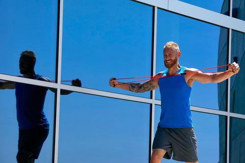 man with works out with a fitness band outside