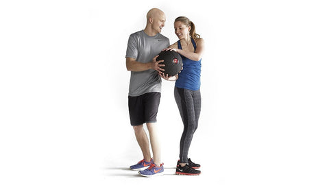 couple hands med ball back and forth to each other