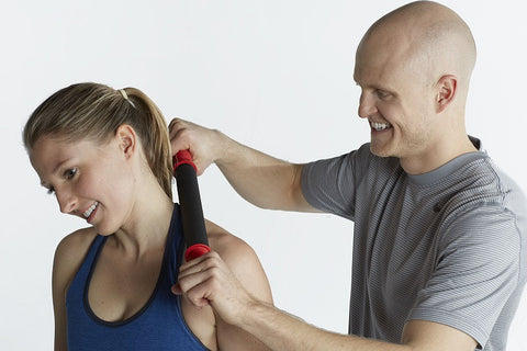 man uses tiger tail massager on womans neck