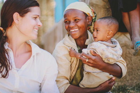 Parkey Clay Co-Founder Brittany Bentley with young mother and child in Ethiopia