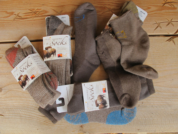 6 pair of bison wool socks on a wooden table