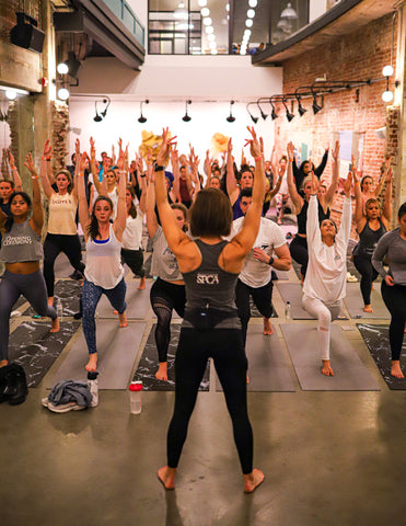 Sydni Arnett leads charity yoga class