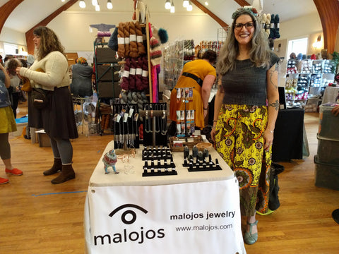 Natalia standing in front of her booth at the Rhinebeck Yarn Bazaar