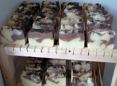 Our delightful Vanilla-Orange Soap curing on the wooden racks - Penny Lane Organics