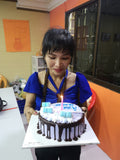 Ava holding her birthday cake with blue marshmellows.