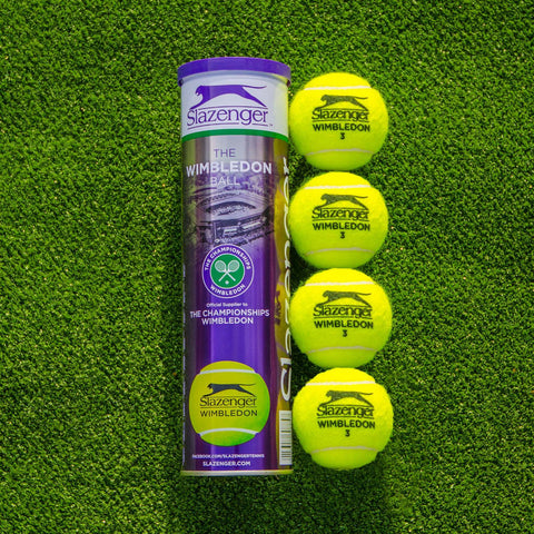 Four Slazenger Wimbledon tennis balls and can on carpet tennis court