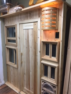 A display showing various windows types, a sauna, and one of our beautiful sconces. All handmade in Sudbury Ontario by Sudbury Cedar Products.