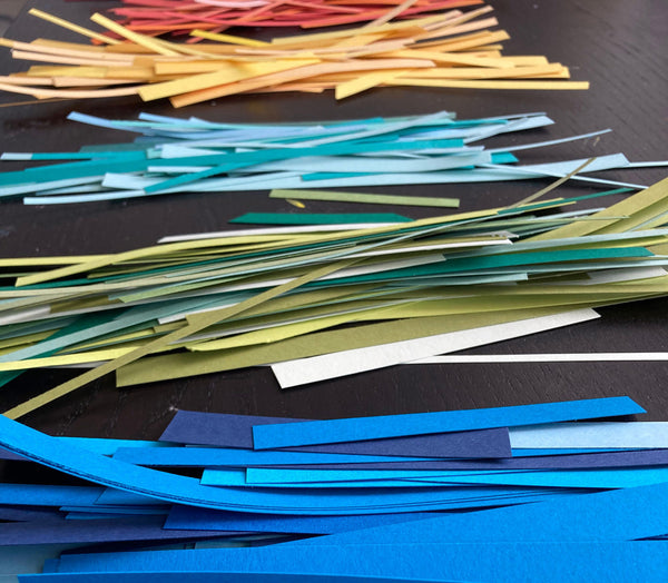 piles of paper scraps sorted by color