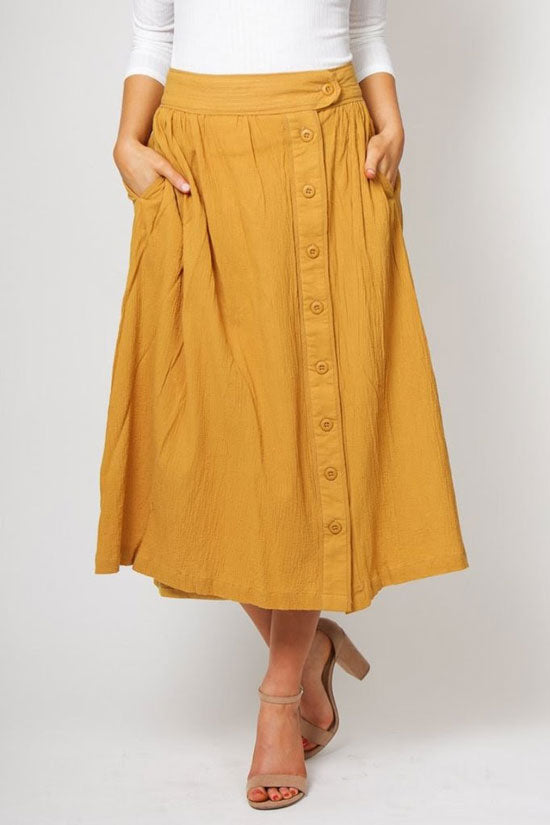 a mustard yellow midi skirt