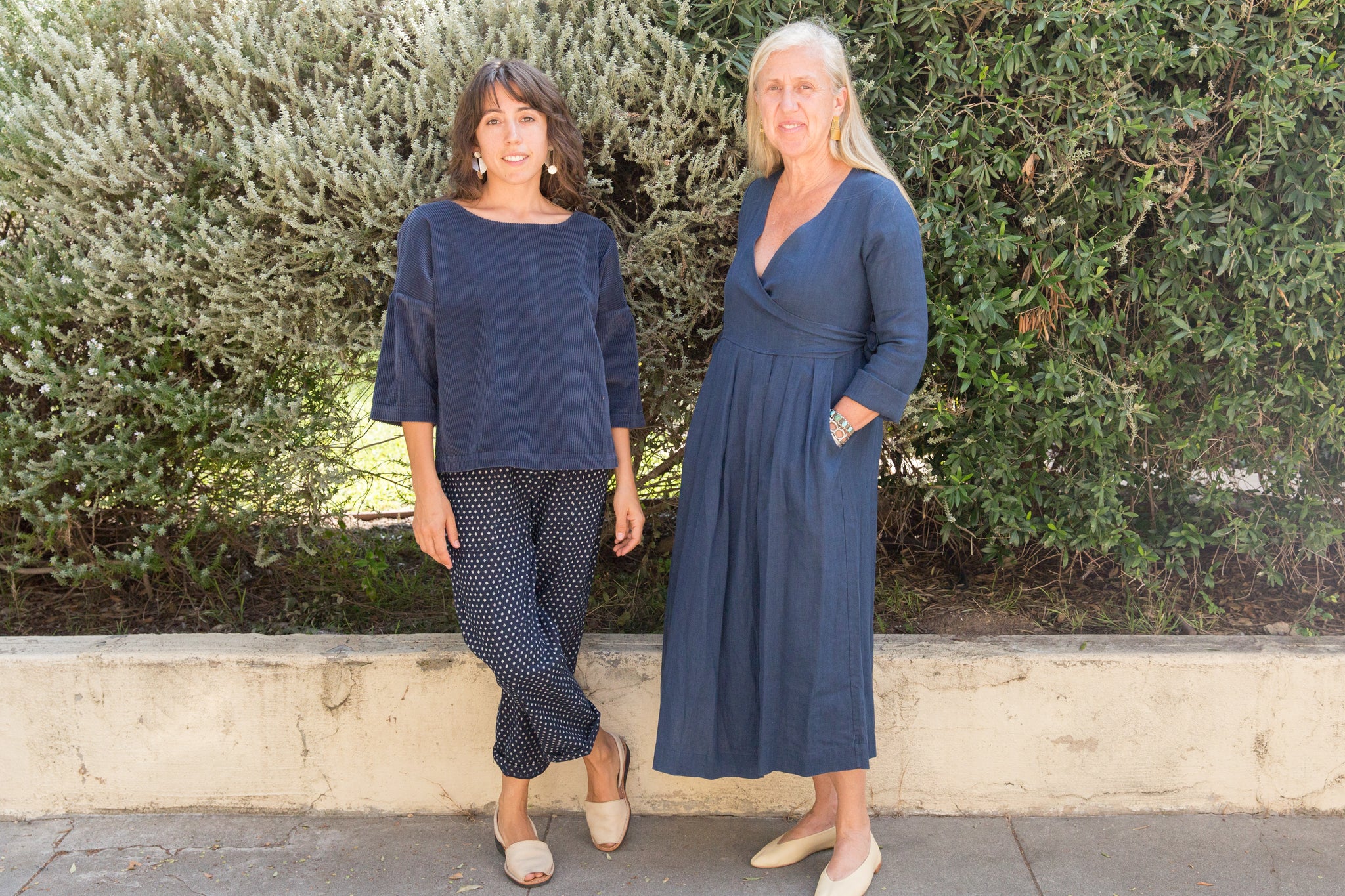 owners of Dotter, Susanne McLean and Annika Huston, standing in front of bushes