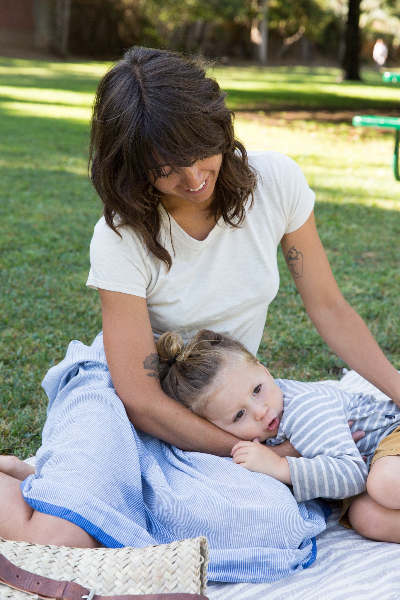 toddler resting head on mama wearing injiri skirt and it is well tee