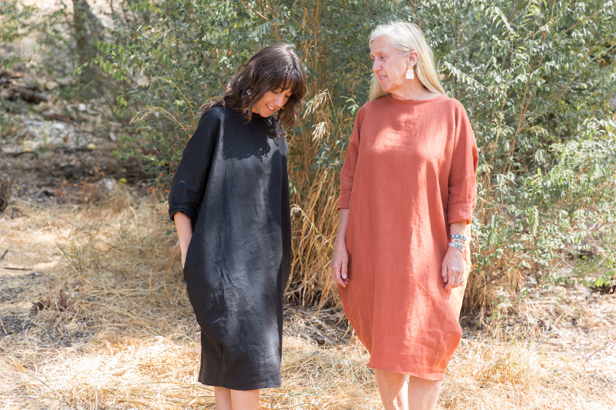 Dotter owners, Susanne McLean and Annika Huston, wearing Robyn King dresses on hill