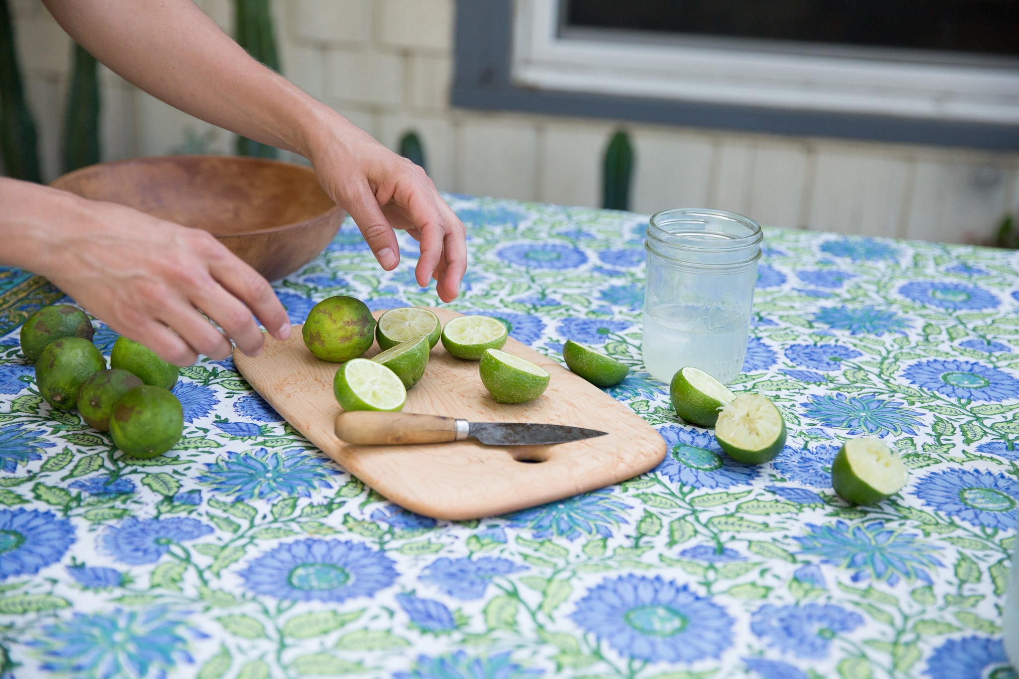 blue and green floral tablecloth with limes on Ed Wohl cutting board