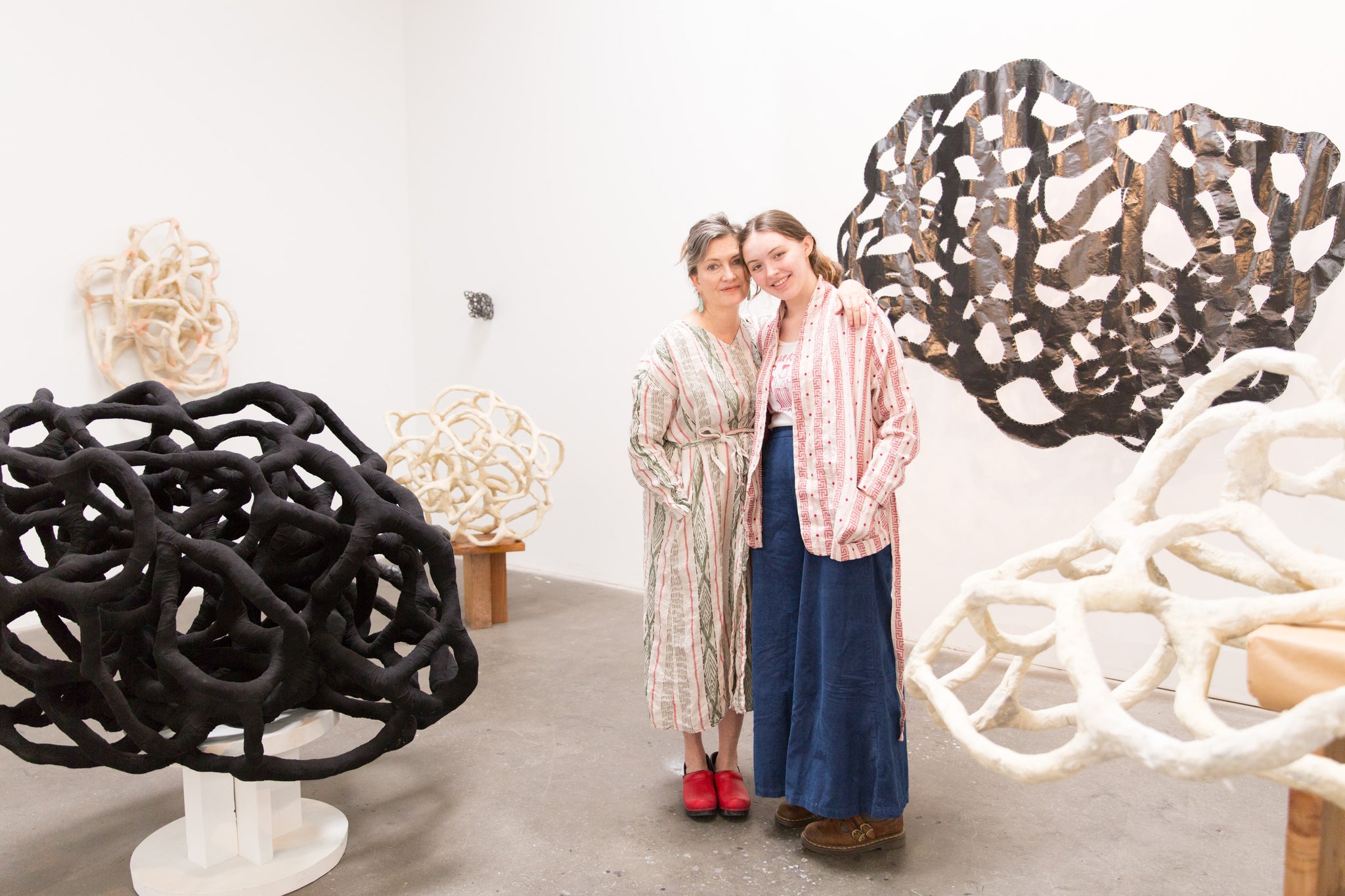 artist Laura Cooper and her daughter surrounded by sculpture in Los Angeles studio