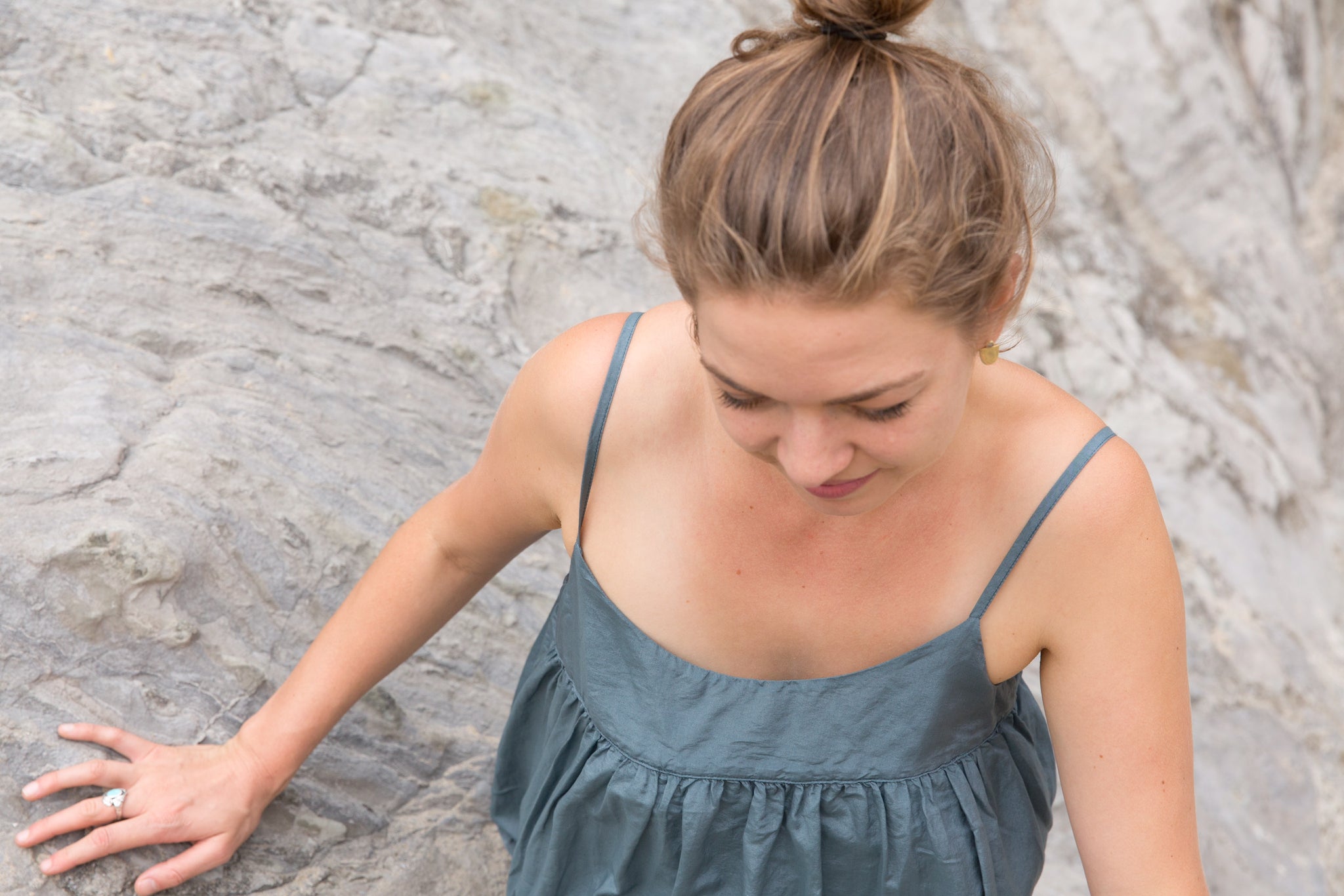 close up of Portland musician, Hanna Haas, climbing on cliffs in CP Shades dress