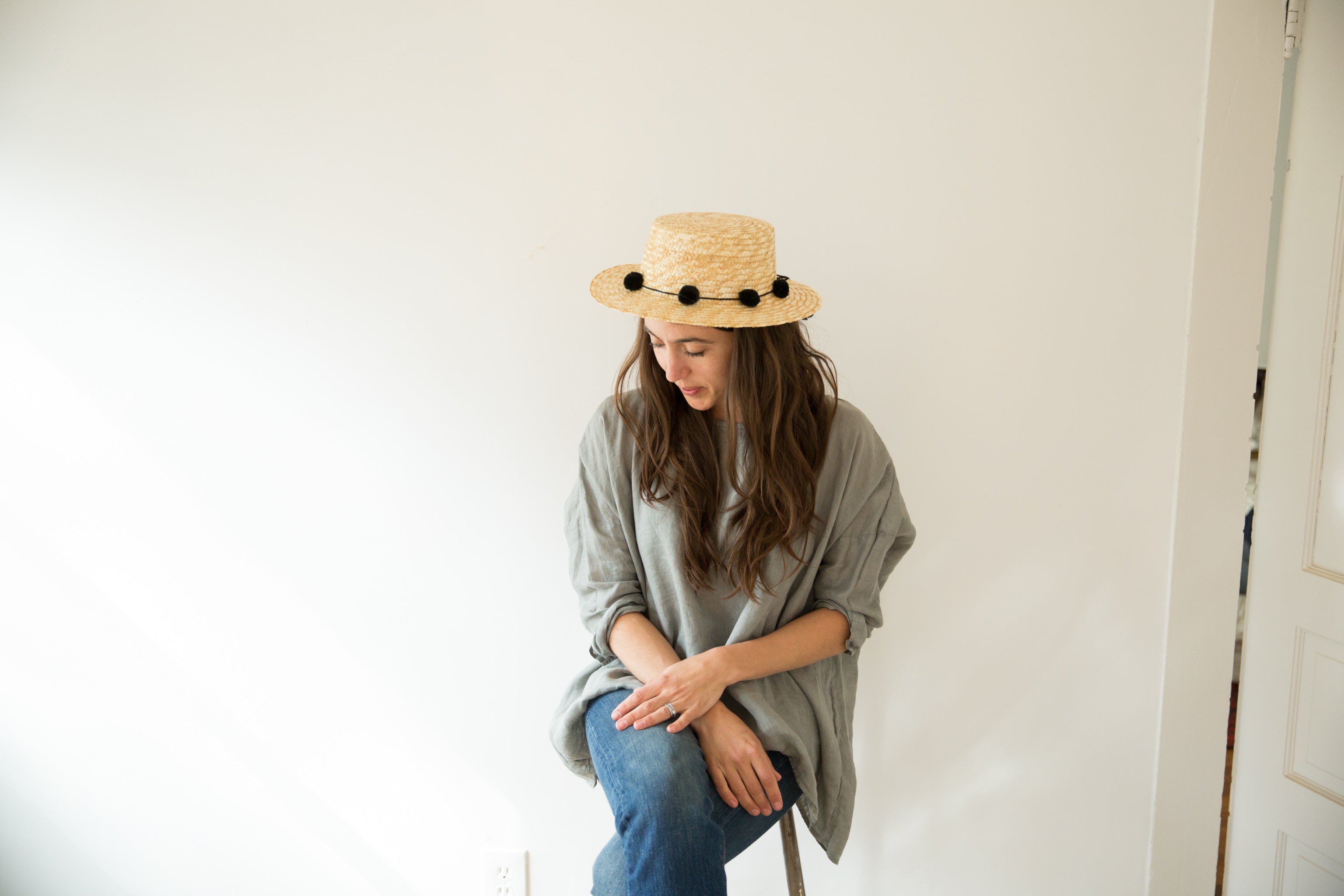 Dotter owner, Annika Huston, wearing CP Shades top and straw hat with pom poms