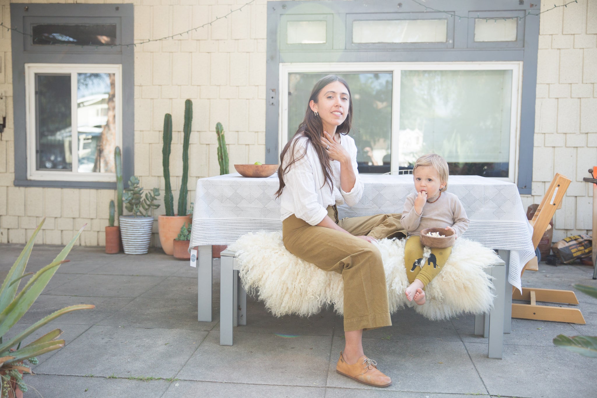 Dotter owner, Annika Huston, sitting at outdoor table with toddler son