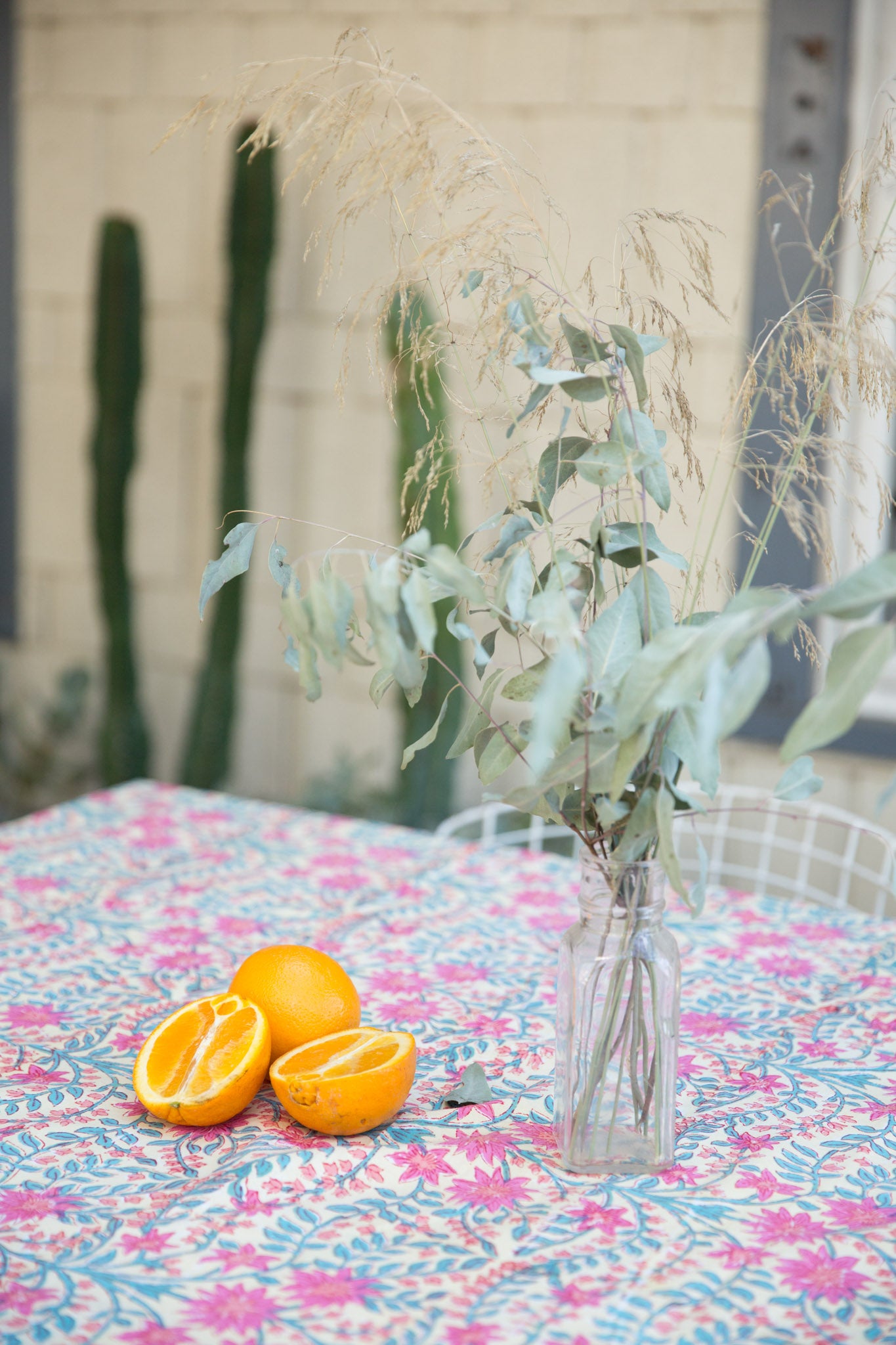pink floral tablecloth with halved oranges