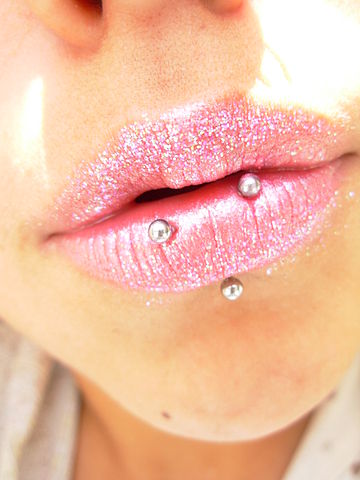 horizontal lip piercing on female