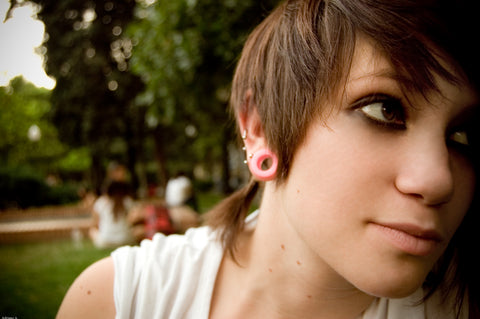 girl with stretched earlobe pink flesh tunnel src wikimedia commons